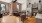 kitchen with stainless steel appliances and living space with large windows