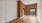 a room with a wood floor and a large window